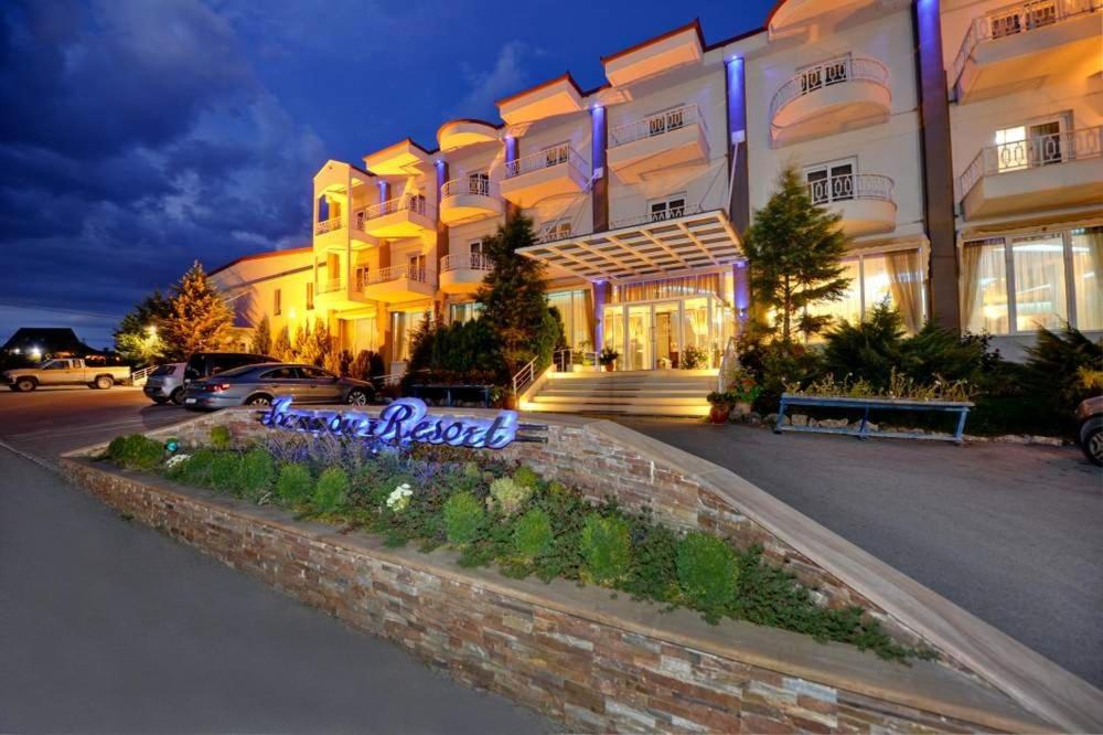 a large building with a sign in front of it at Ioannou Resort in Ptolemaida