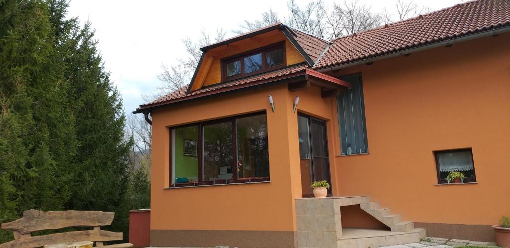 a small orange house with a window at Apartment Pri Vrtnici in Šmartno ob Paki