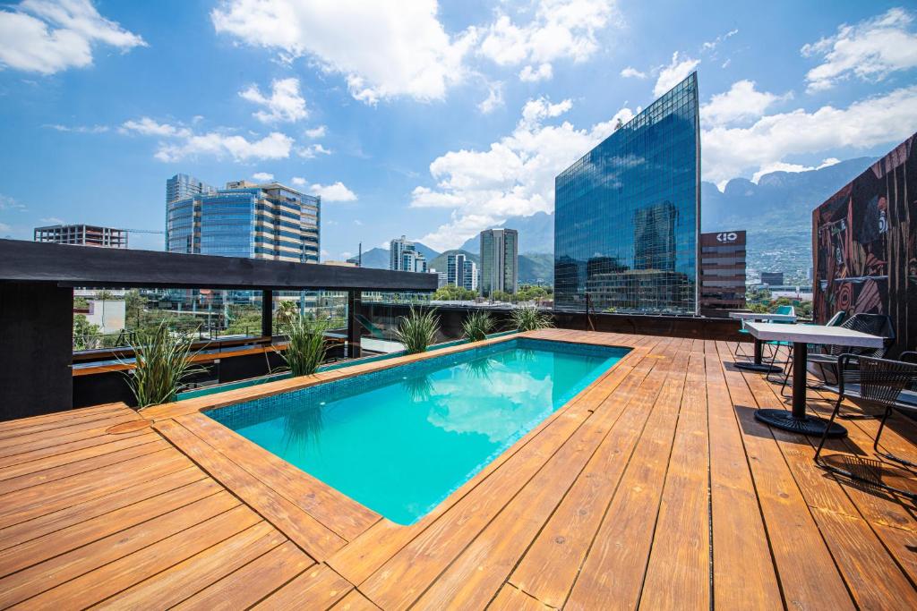 a rooftop deck with a swimming pool on a building at Autentico Monterrey in Monterrey