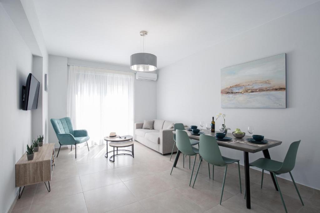 a living room with a dining room table and chairs at Casa Ntore Luxury Apartments in Chania Town