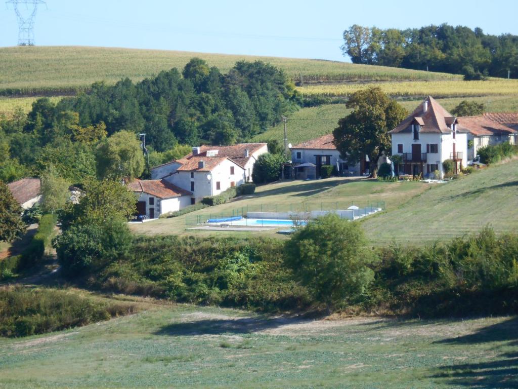 a house on a hill with a swimming pool at Coutancie in Nanteuil-de-Bourzac