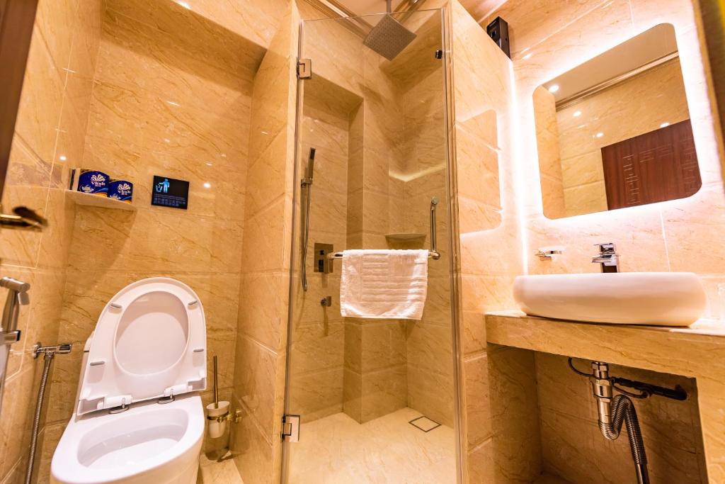 a bathroom with a toilet and a sink at AC Residence - Behind Cititel Hotel in Kota Kinabalu