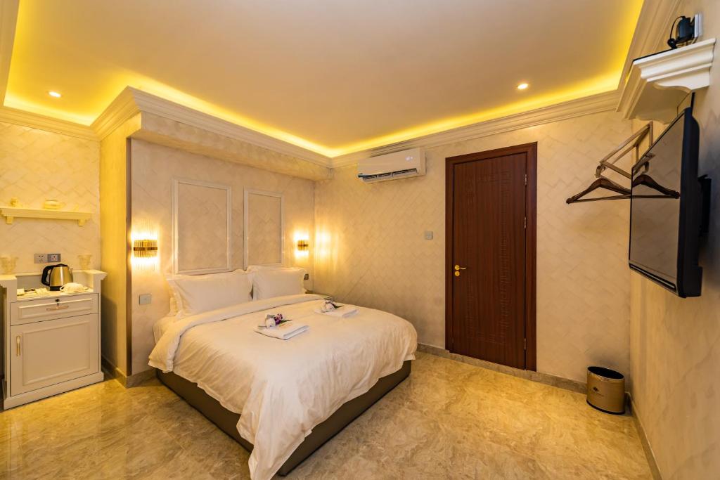 a bedroom with a large bed and a television at AC Residence - Behind Cititel Hotel in Kota Kinabalu