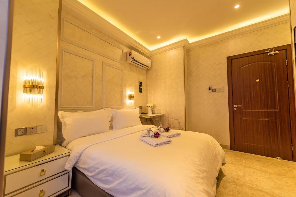 a bedroom with a white bed with a tray on it at AC Residence - Behind Cititel Hotel in Kota Kinabalu