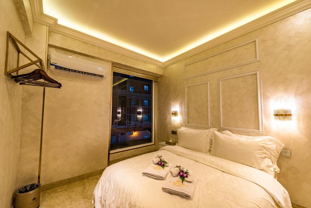 a bedroom with a bed with two trays on it at AC Residence - Behind Cititel Hotel in Kota Kinabalu