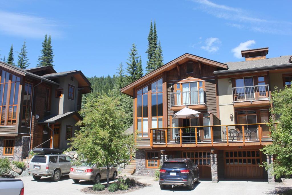 a large building with cars parked in a parking lot at Woodhaven # 8 in Sun Peaks in Sun Peaks