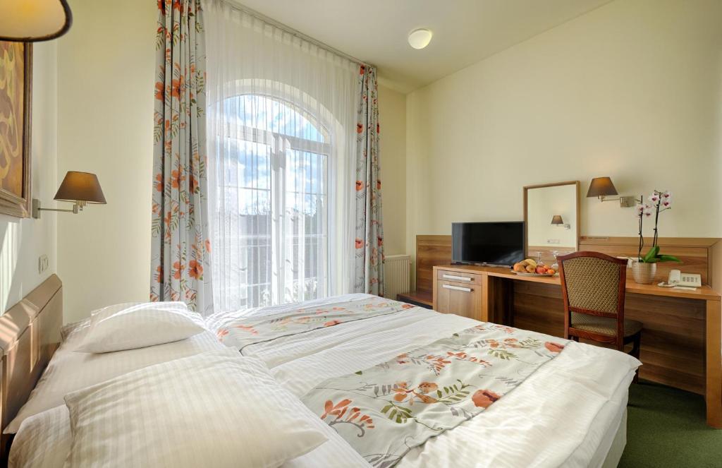 Postel nebo postele na pokoji v ubytování Hotel Kiss