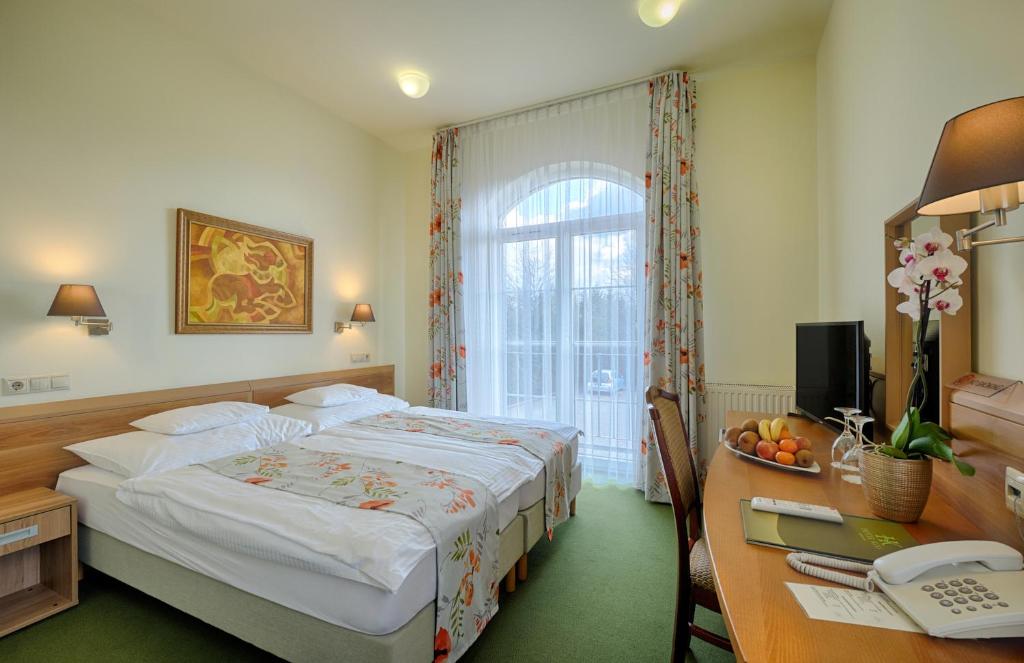 Postel nebo postele na pokoji v ubytování Hotel Kiss