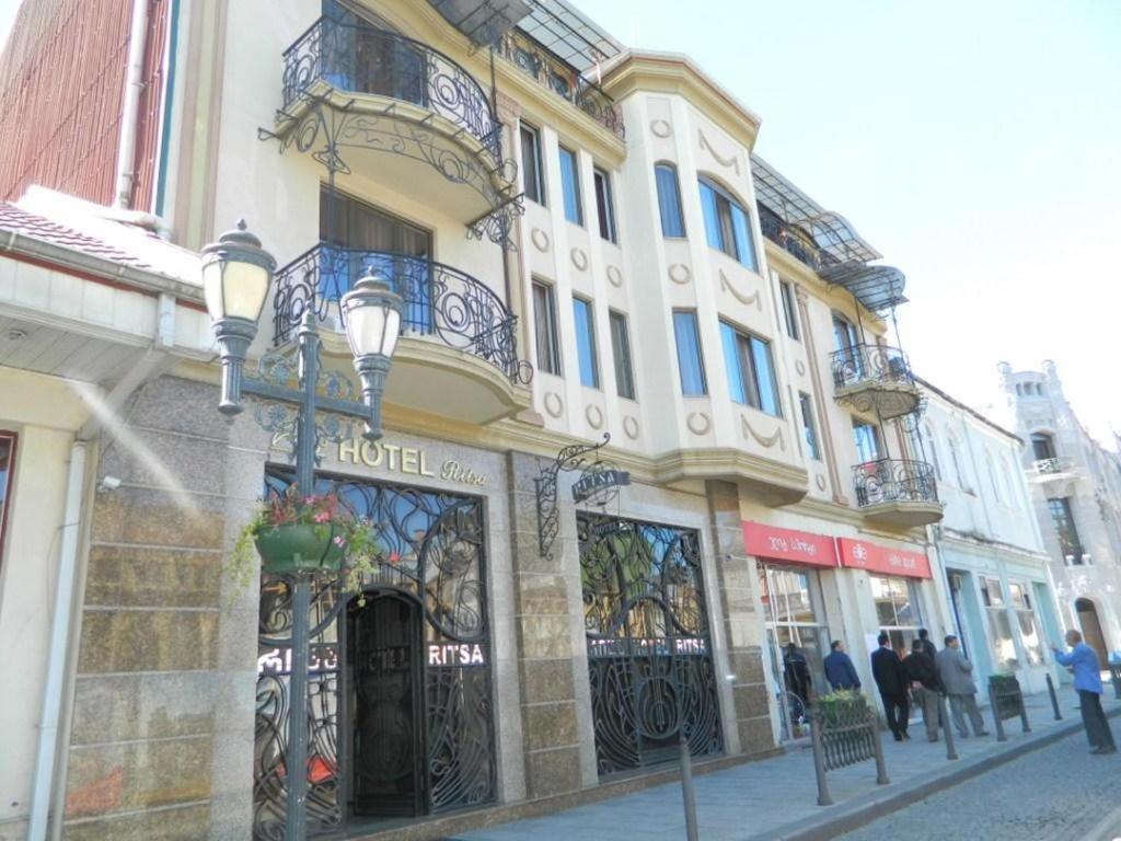 a building on a street with people walking on the street at Hotel Ritsa in Batumi