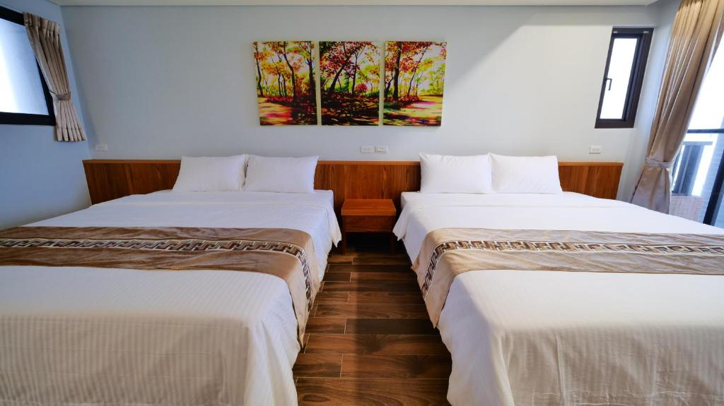 Postel nebo postele na pokoji v ubytování Apause Hotel