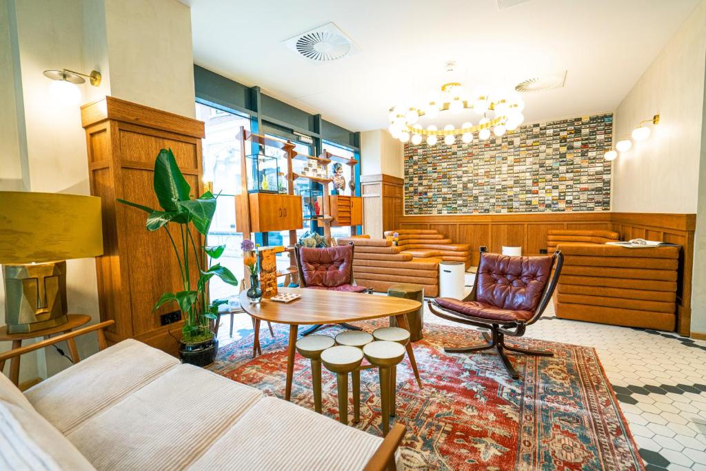 a living room with a couch and a table and chairs at The Collector in The Hague