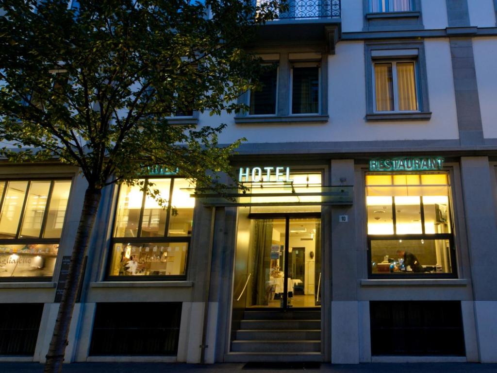 a store front of a hotel with lights in the windows at Hotel Scheuble in Zürich