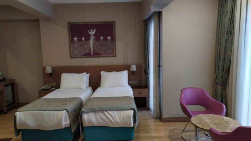Postel nebo postele na pokoji v ubytování Taximist Hotel