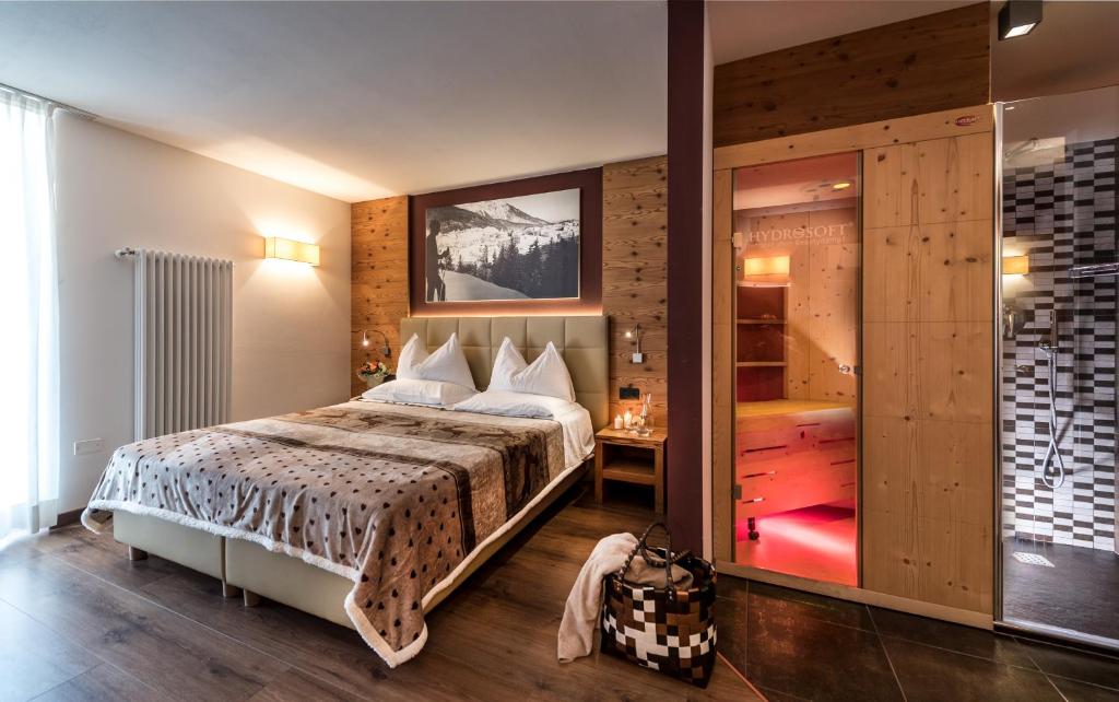 Postel nebo postele na pokoji v ubytování Sassdei My Active Suite Hotel