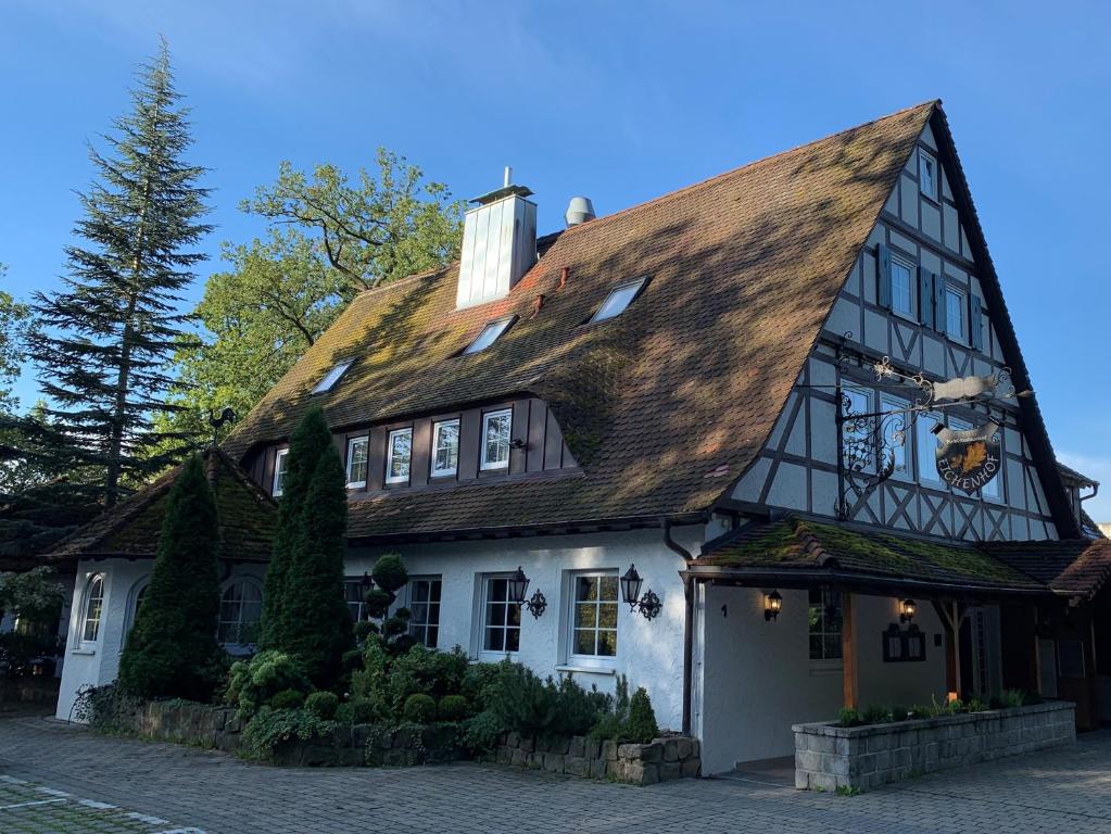 a white house with a brown roof at Waldhotel Eichenhof in Aalen