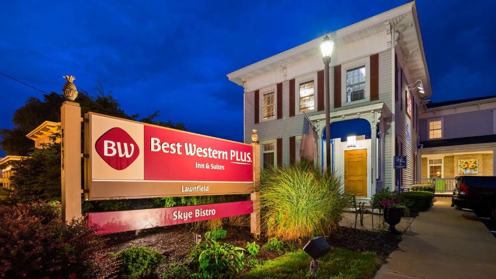 a building with a sign in front of a house at Best Western Plus Mentor-Cleveland Northeast in Mentor