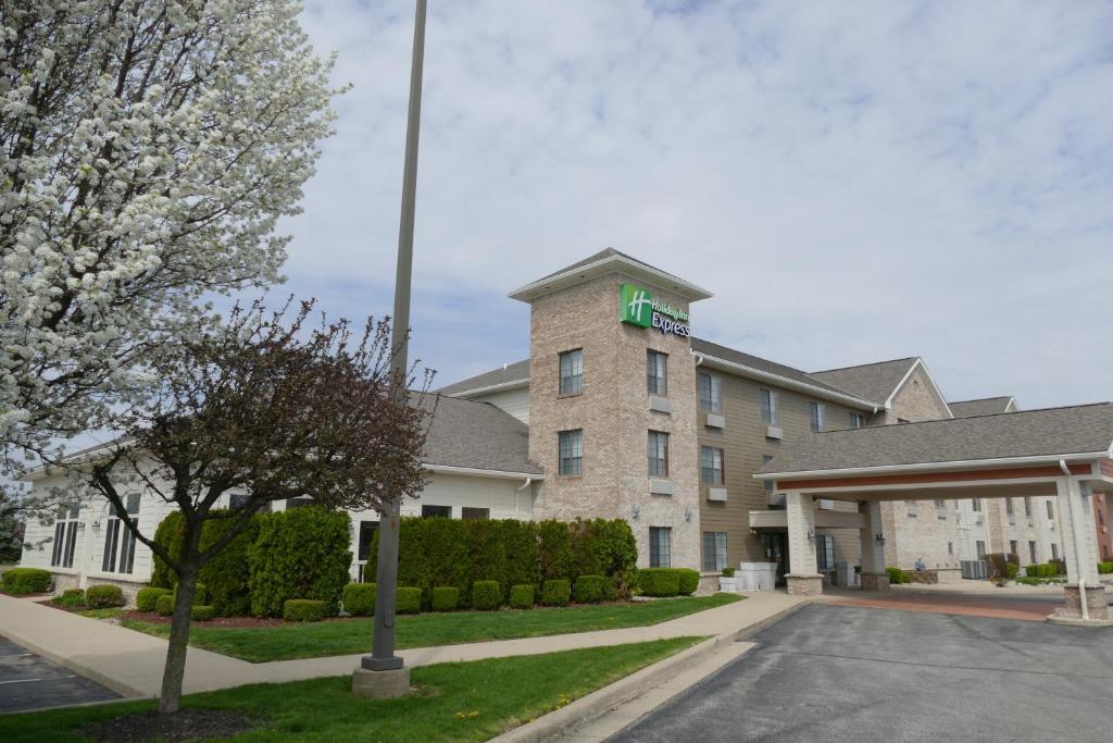 a building with a green cross on top of it at Holiday Inn Express Greensburg, an IHG Hotel in Greensburg