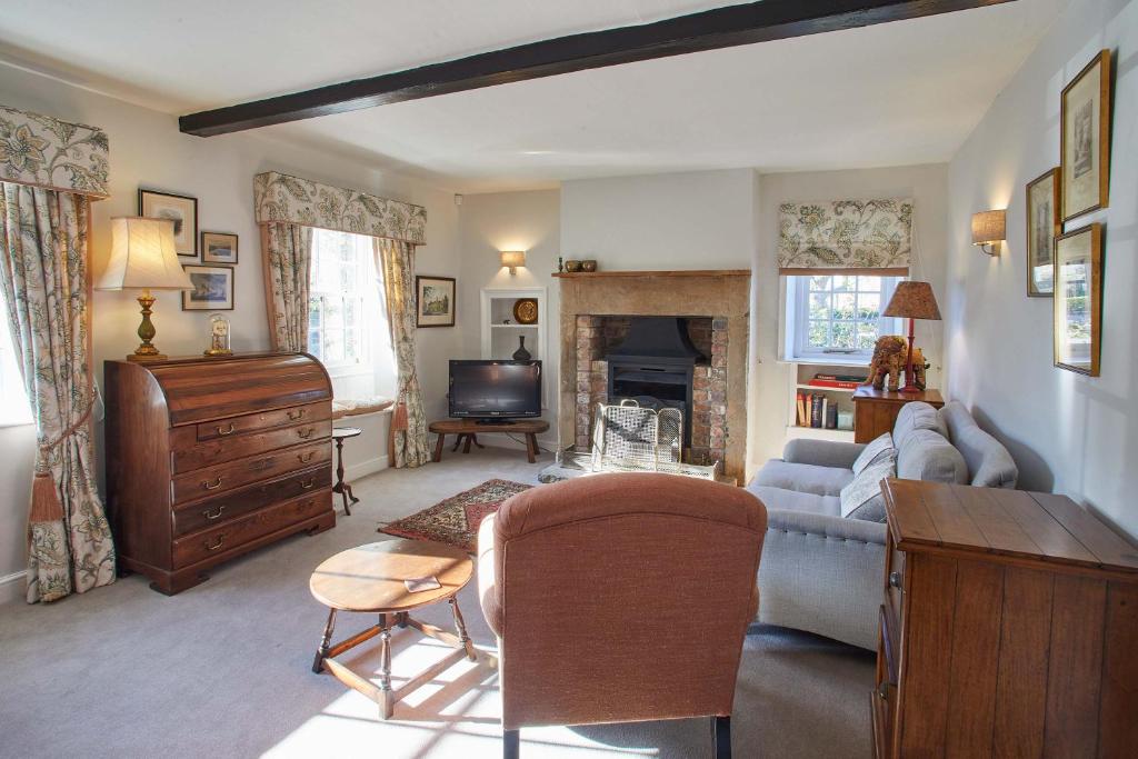 a living room with a couch and a table at Host & Stay - Tithe Cottage in Harrogate