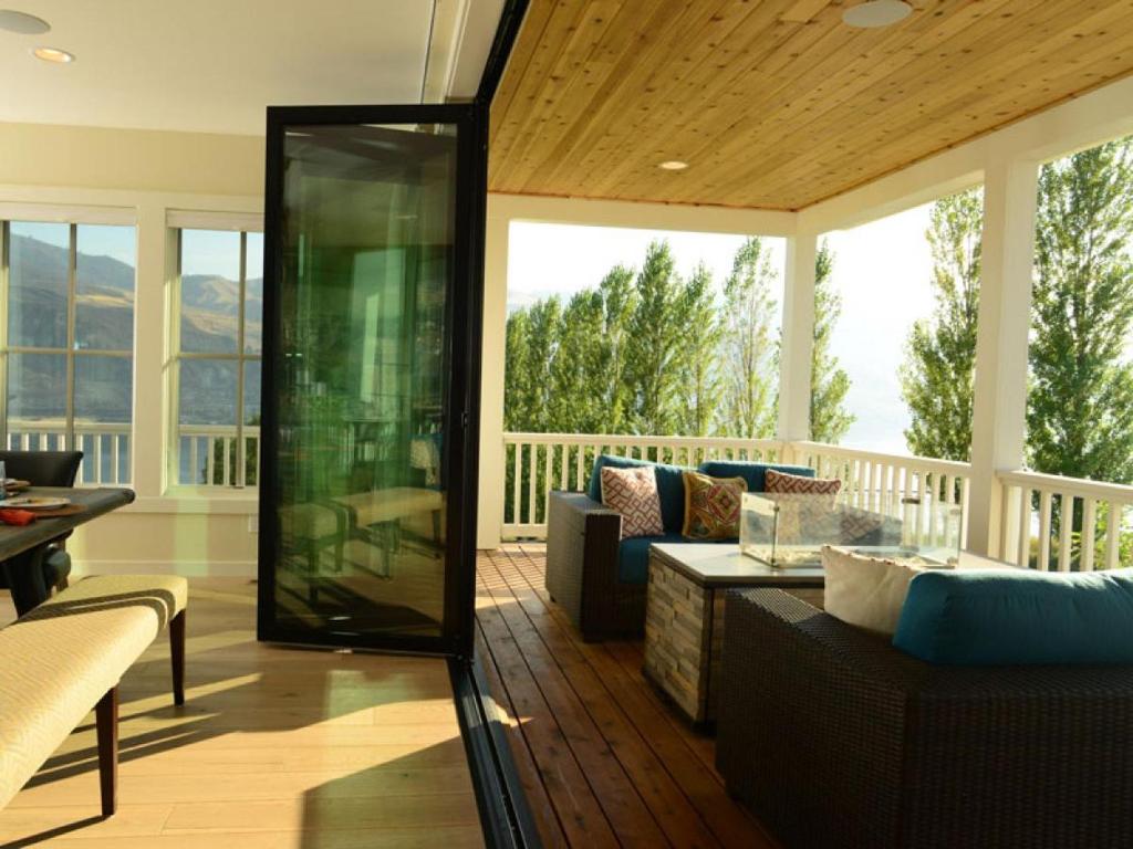 a screened in porch with a couch and a table at Arroyo #60 in Chelan