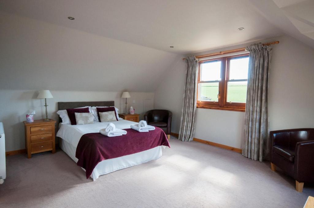 Un dormitorio con una cama grande y una ventana en Chapel of Barras B&B, en Stonehaven