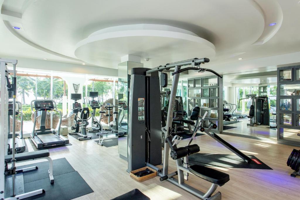 a gym with several tread machines in a room at Katathani Phuket Beach Resort - SHA Extra Plus in Kata Beach
