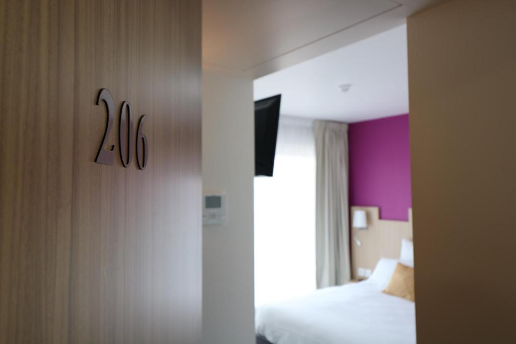 Postel nebo postele na pokoji v ubytování Hotel Le Virevent
