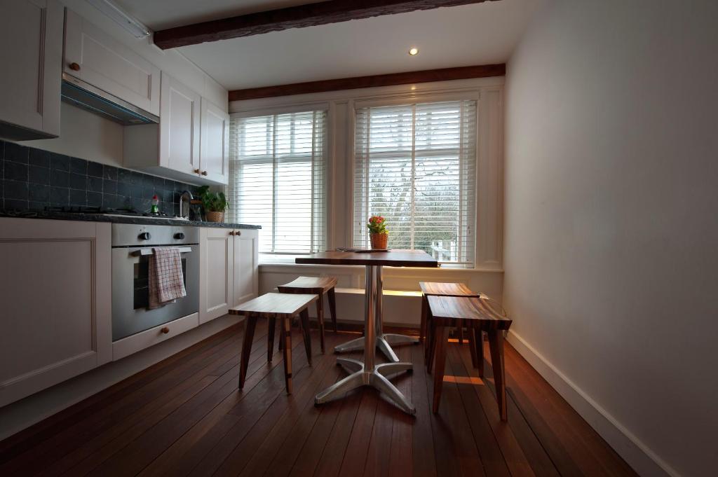 a kitchen with a table and some chairs in it at Bed & Breakfast The 9 Streets in Amsterdam