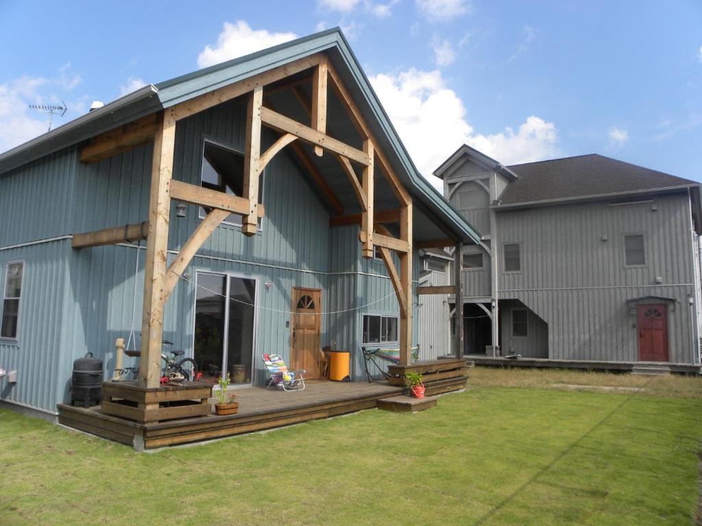a large barn with a porch and a house at B&BHOUSE FAM in Ichinomiya