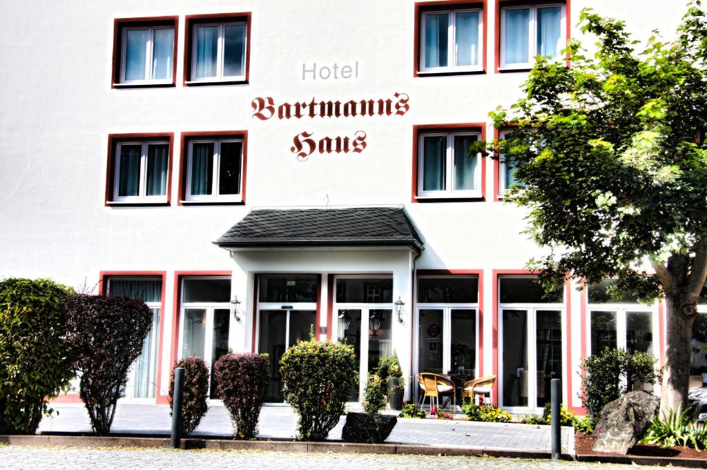 a hotel with the name of the hotel and its windows at Hotel Bartmanns Haus in Dillenburg
