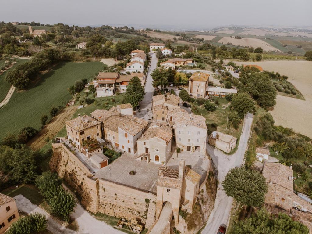 an aerial view of an old castle with a river at Borgo Loretello in Loretello