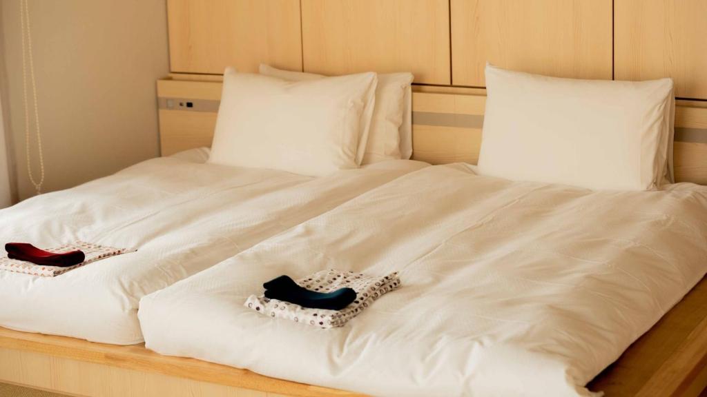 Postel nebo postele na pokoji v ubytování GEN HOTEL KAMAKURA