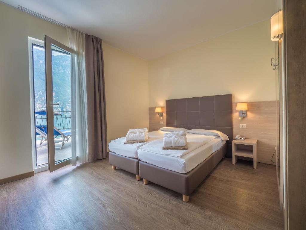 Postel nebo postele na pokoji v ubytování Hotel Capo Reamol