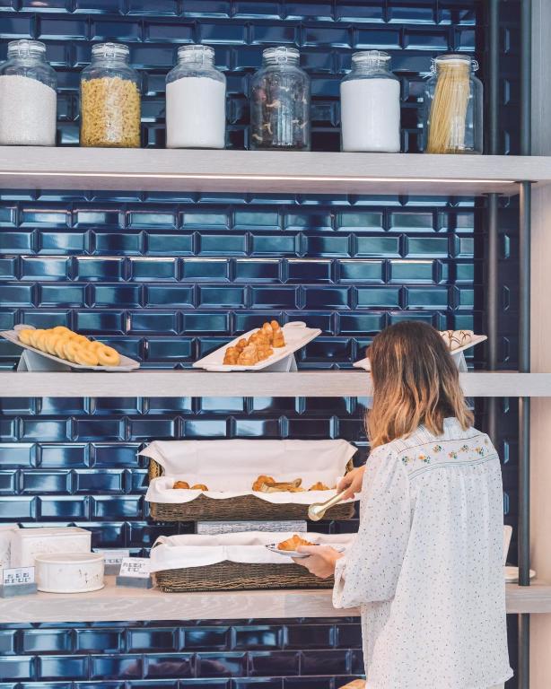 a woman standing in front of a shelf with food at Seventy Barcelona in Barcelona