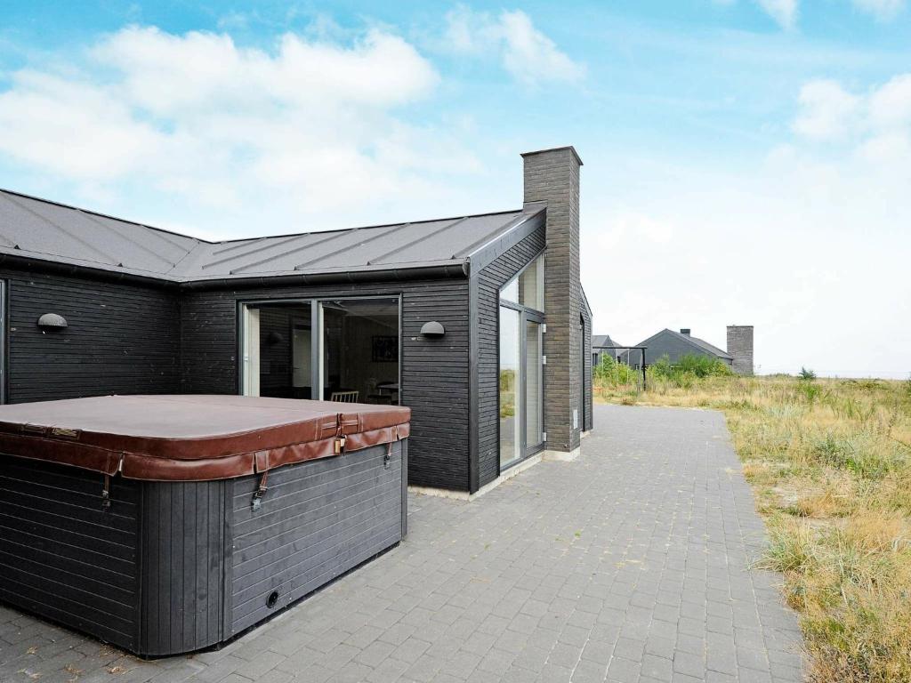 a house with a hot tub on the side of it at Four-Bedroom Holiday home in Rømø 5 in Rømø Kirkeby