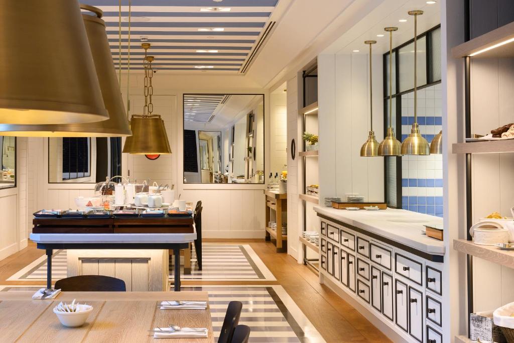 a kitchen with a table and a dining room at Seventy Barcelona in Barcelona