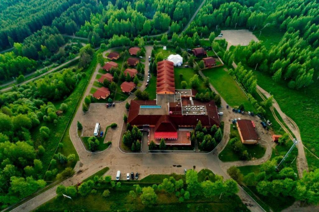 an aerial view of a large house in the middle of a forest at AZIMUT Hotel Kostroma in Kostroma