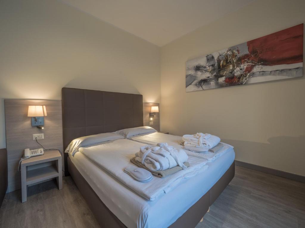 Postel nebo postele na pokoji v ubytování Hotel Capo Reamol