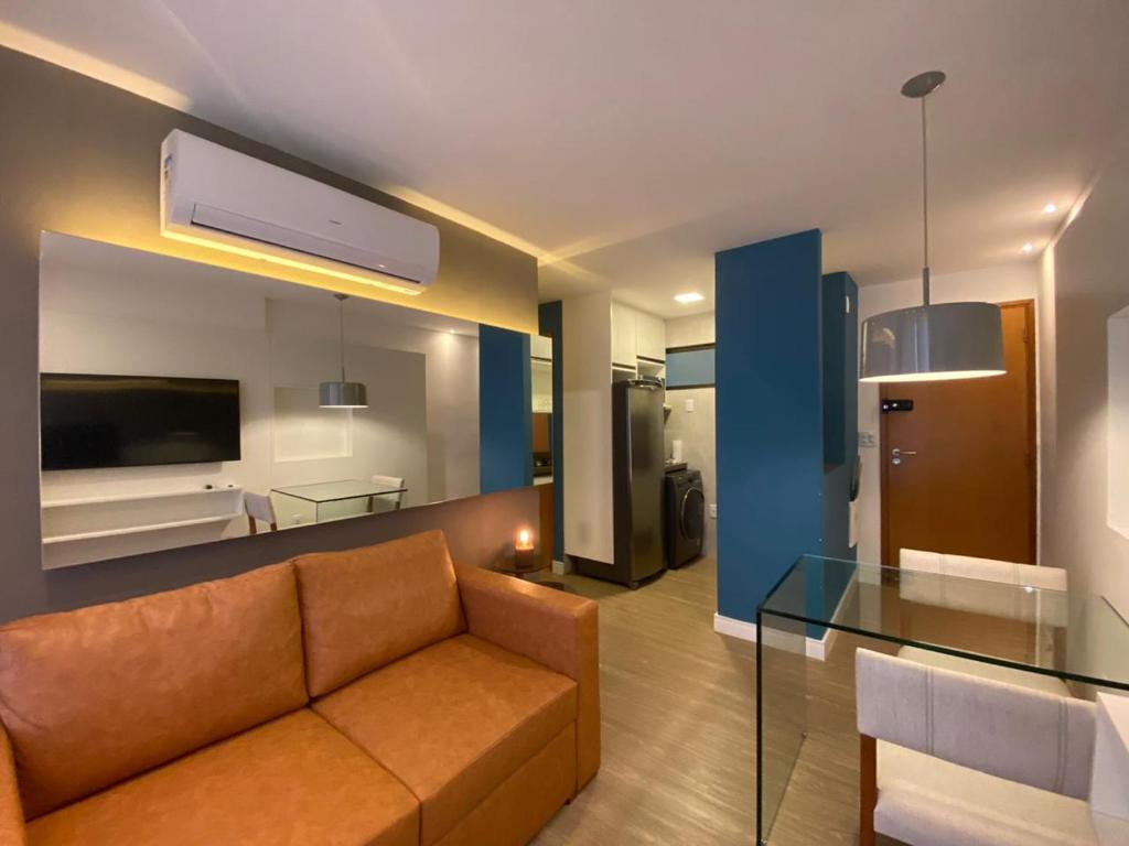 a living room with a couch and a glass table at Apartamento de Luxo em Boa Viagem Perto da Praia. in Recife