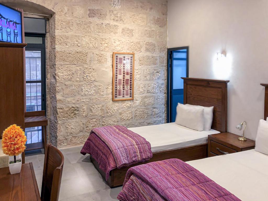 Postel nebo postele na pokoji v ubytování New Imperial Hotel