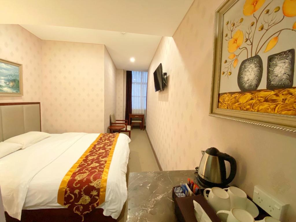 Postel nebo postele na pokoji v ubytování Megaboom City Hotel