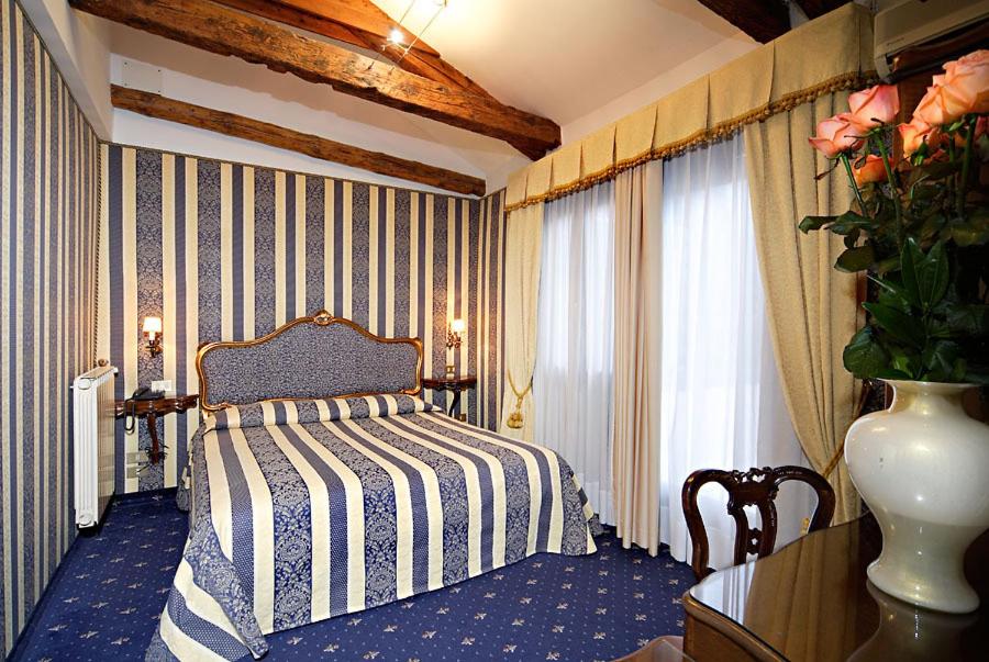 Postel nebo postele na pokoji v ubytování Centauro Hotel