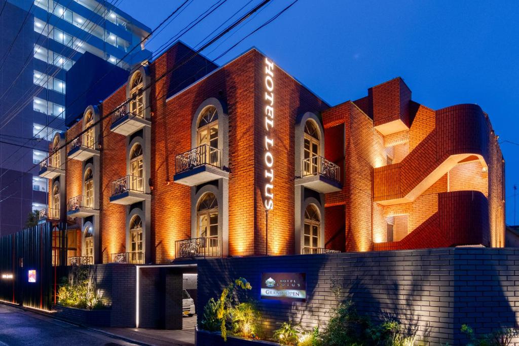 a red brick building with a sign on it at Hotel Lotus Koiwa (Adult Only) in Tokyo