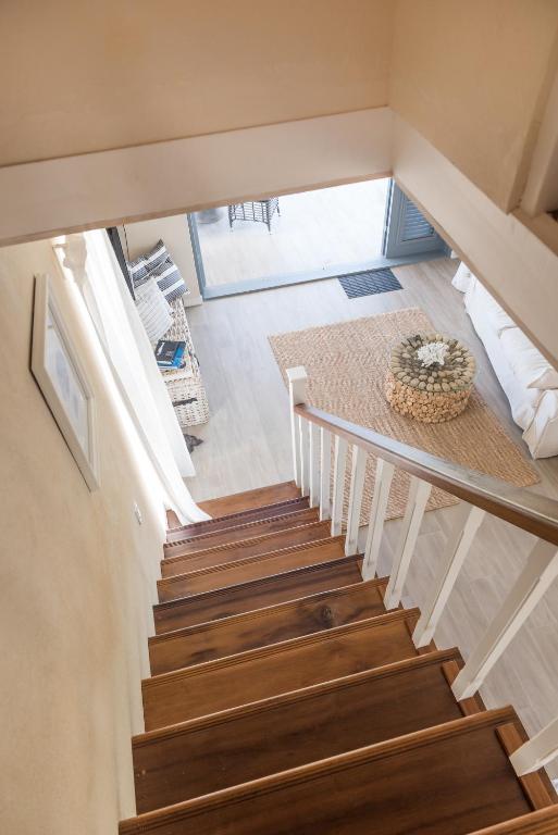 a stairway in a house with wooden stairs at West Rock Villas in Saint James