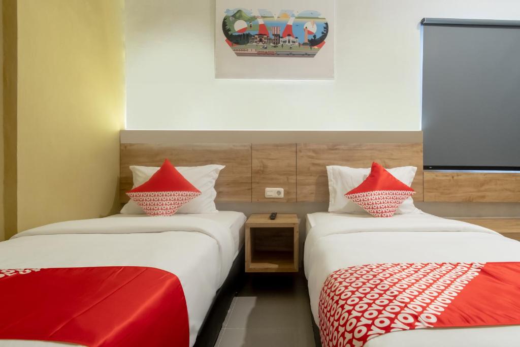 Postel nebo postele na pokoji v ubytování OYO 3159 Festive Inn