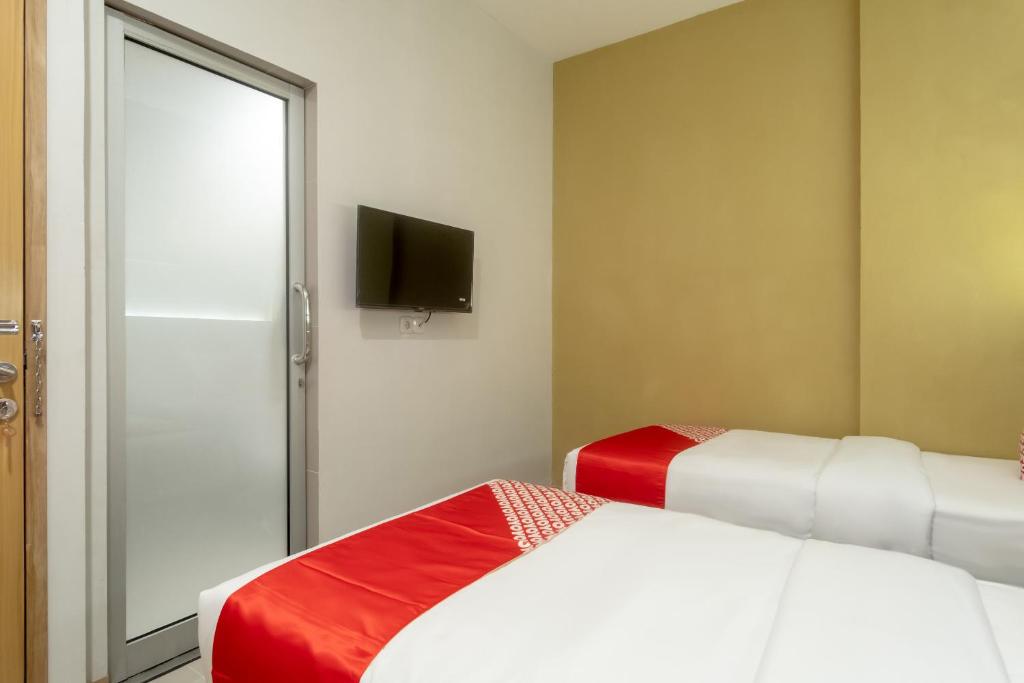 Postel nebo postele na pokoji v ubytování OYO 3159 Festive Inn