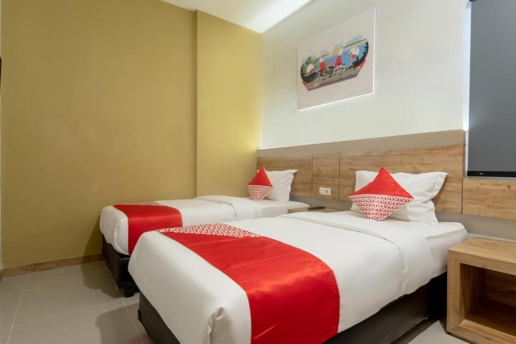 Postel nebo postele na pokoji v ubytování OYO 3159 Festive Inn