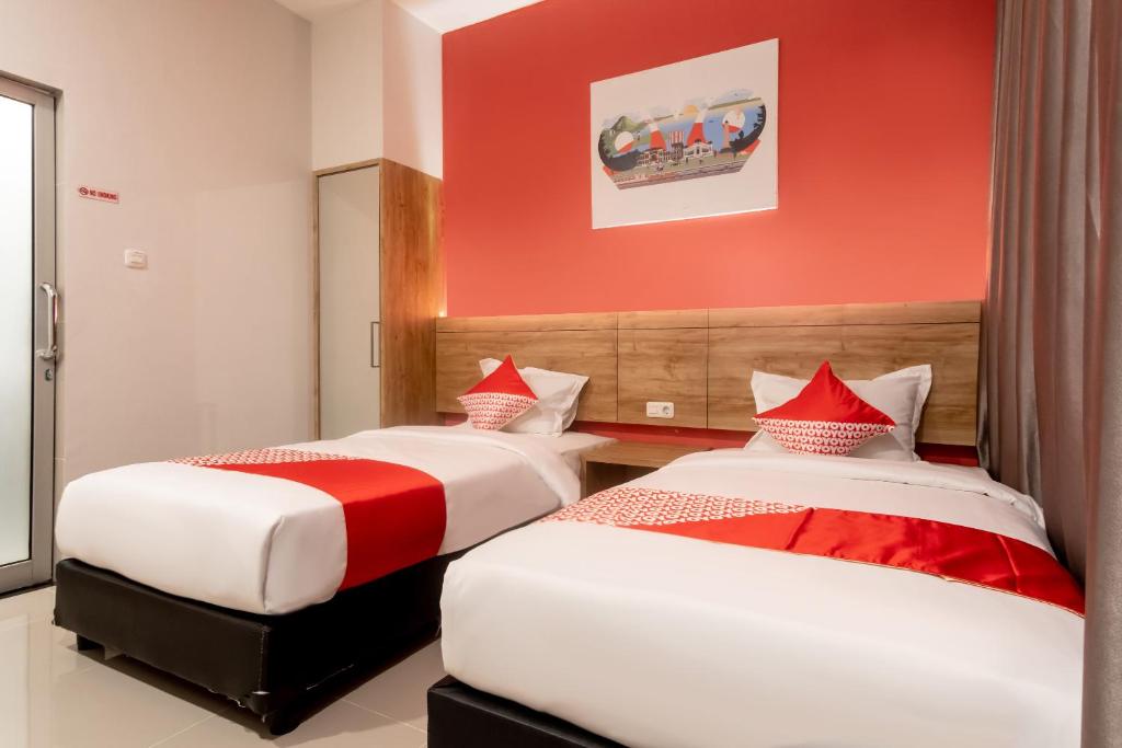Postel nebo postele na pokoji v ubytování OYO 3159 Festive Inn