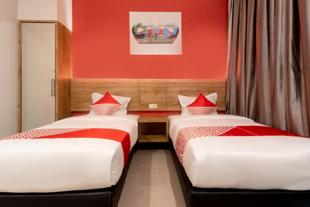 Postel nebo postele na pokoji v ubytování OYO 3159 Festive Inn
