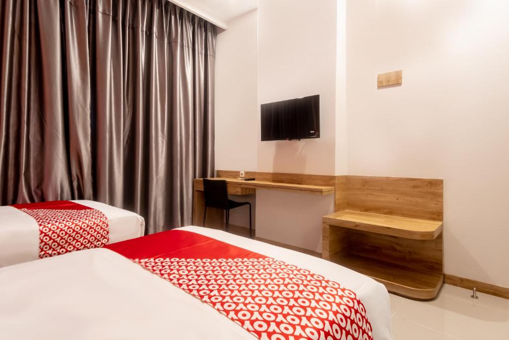 Postel nebo postele na pokoji v ubytování OYO 3159 Festive Inn