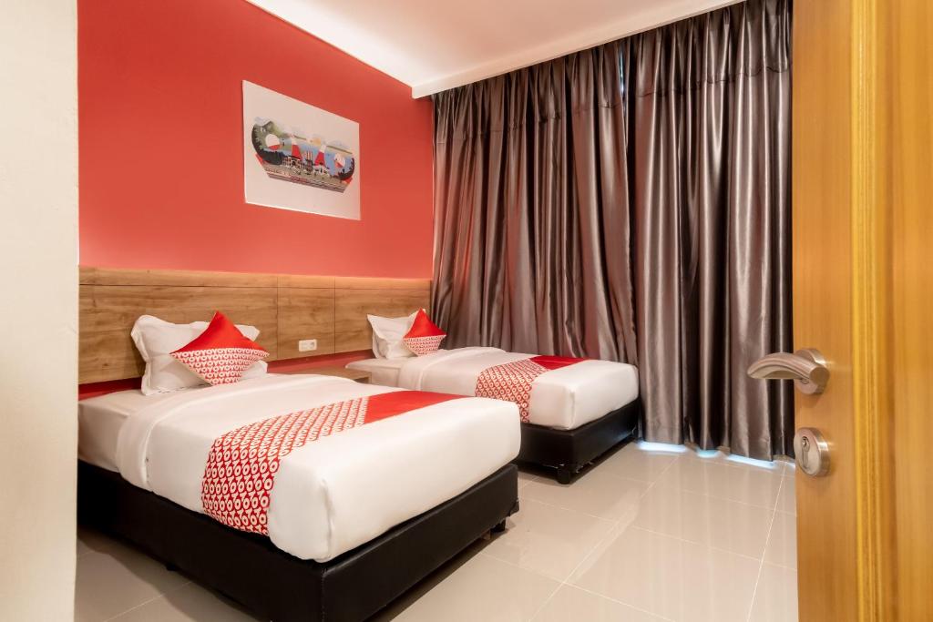 Postel nebo postele na pokoji v ubytování OYO 3159 Festive Inn